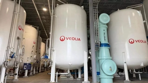 Veolia branded water filtration tanks and pipework inside a water treatment plant with blue pipe fittings